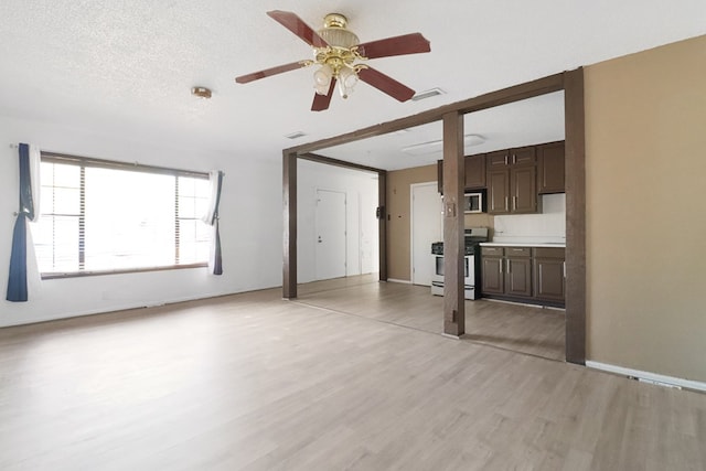 3633 Melody Ln, Odessa, TX 79762 - unfurnished living room with light wood finished floors and ceiling fan