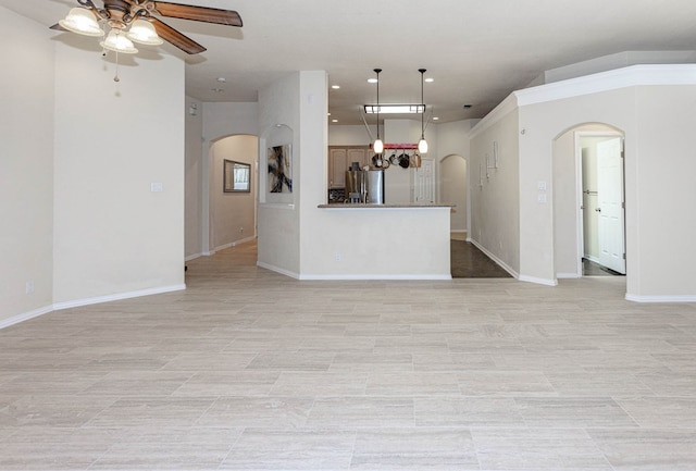 6921 Stonehenge Rd, Odessa, TX 79765 - unfurnished living room featuring arched walkways, ceiling fan, and recessed lighting