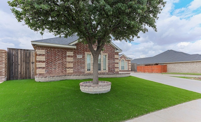 6921 Stonehenge Rd, Odessa, TX 79765 - view of front of home featuring brick siding and roof with shingles