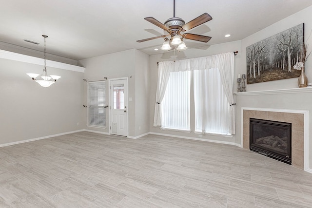 6921 Stonehenge Rd, Odessa, TX 79765 - unfurnished living room featuring ceiling fan, a chandelier, a tile fireplace, and recessed lighting