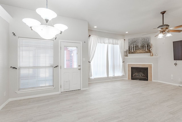 6921 Stonehenge Rd, Odessa, TX 79765 - unfurnished living room featuring a ceiling fan, a fireplace, recessed lighting, and wood finished floors