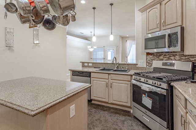 6921 Stonehenge Rd, Odessa, TX 79765 - kitchen with stainless steel appliances, light brown cabinets, decorative backsplash, a peninsula, and recessed lighting
