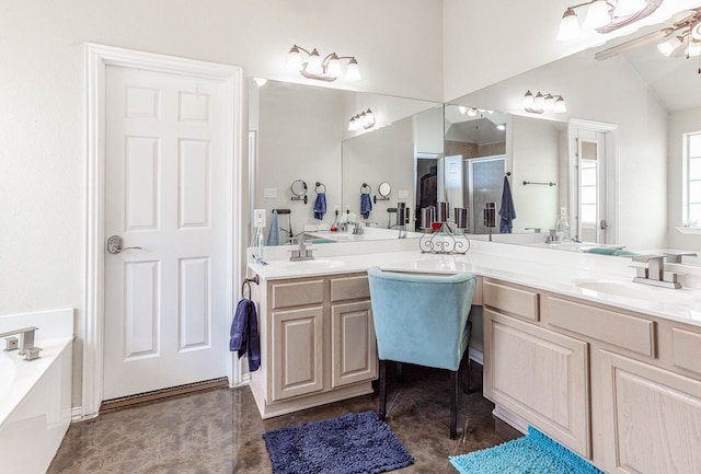 6921 Stonehenge Rd, Odessa, TX 79765 - bathroom featuring a shower stall, double vanity, a garden tub, and lofted ceiling