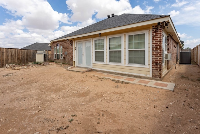 6921 Stonehenge Rd, Odessa, TX 79765 - back of property with brick siding, a fenced backyard, and roof with shingles