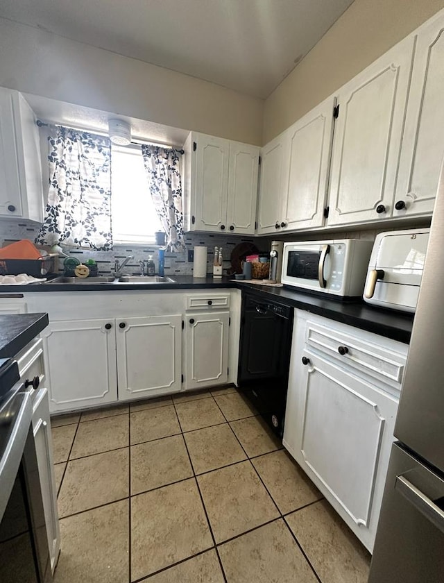 900 N Colpitts Ft, Stockton, TX 79735 - kitchen featuring white microwave, black dishwasher, dark countertops, white cabinets, and a sink