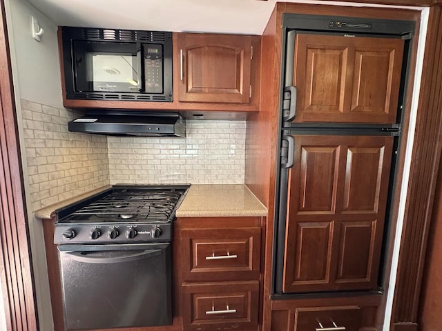 287 Fulcher Rd, Terlingua, TX 79852 - kitchen with range with gas stovetop, black microwave, light countertops, decorative backsplash, and exhaust hood
