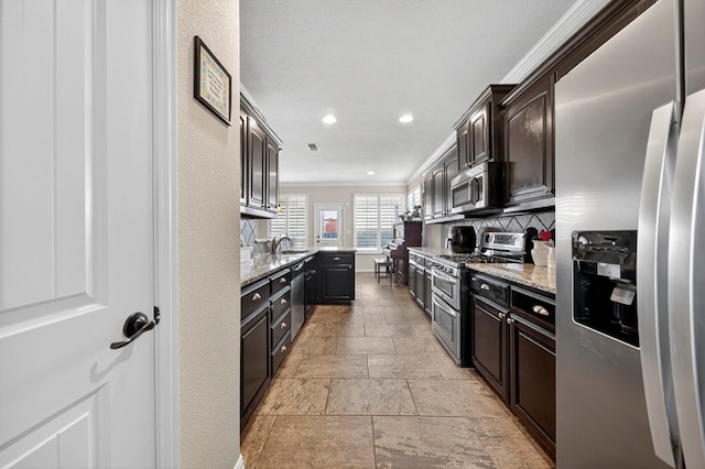 606 Rainbow Ct, Odessa, TX 79765 - kitchen featuring stainless steel appliances, stone tile flooring, tasteful backsplash, light stone countertops, and recessed lighting