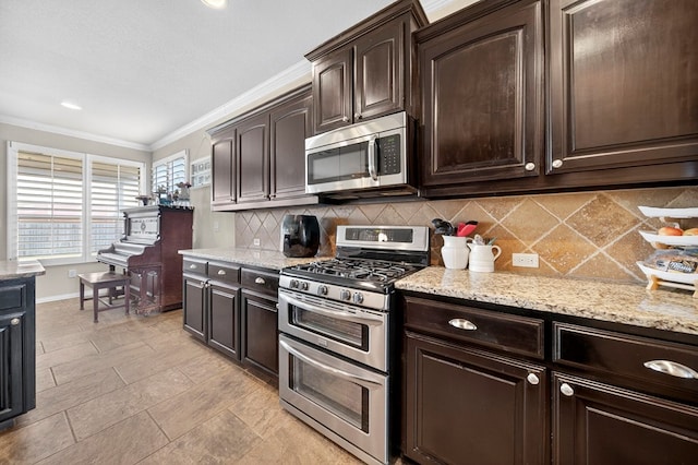 606 Rainbow Ct, Odessa, TX 79765 - kitchen featuring stainless steel appliances, ornamental molding, tasteful backsplash, dark brown cabinets, and light stone counters