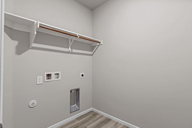 washroom featuring laundry area, hookup for a washing machine, baseboards, wood finished floors, and hookup for an electric dryer