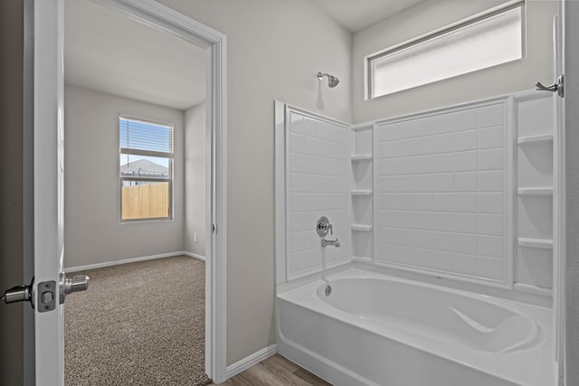 bathroom featuring baseboards and shower / bathing tub combination