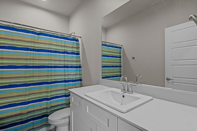 bathroom featuring toilet, a shower with curtain, and vanity