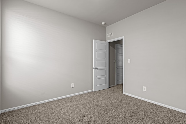 unfurnished room featuring baseboards, carpet, and visible vents