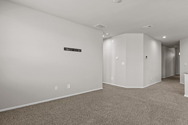 unfurnished room featuring recessed lighting, baseboards, visible vents, and carpet