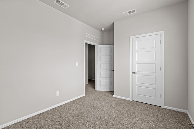 unfurnished bedroom featuring carpet flooring, baseboards, and visible vents