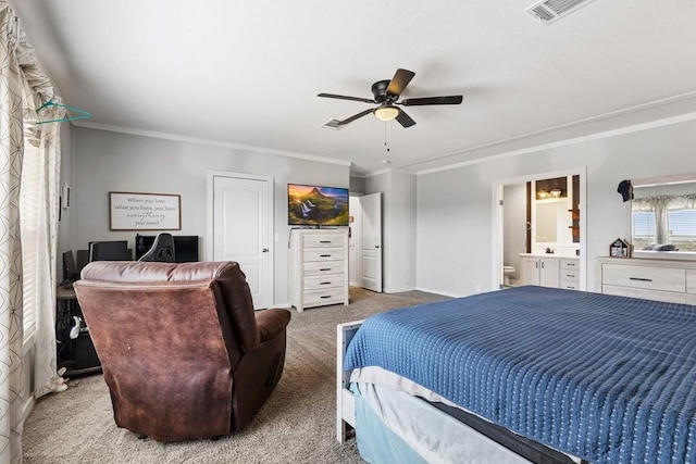 carpeted bedroom with ensuite bathroom, ceiling fan, and crown molding