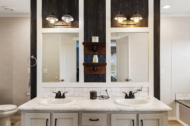 bathroom featuring vanity and toilet