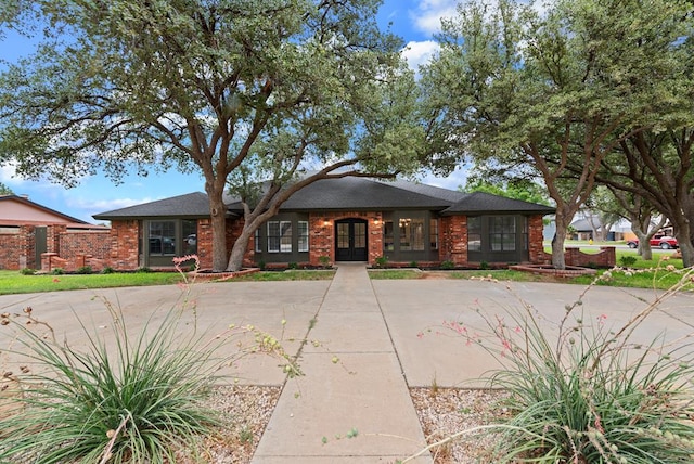 20 Sunnygrove Dr, Odessa, TX 79761 - view of front facade with french doors and brick siding