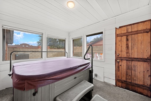 20 Sunnygrove Dr, Odessa, TX 79761 - sunroom / solarium with a jacuzzi, carpet floors, and wooden walls