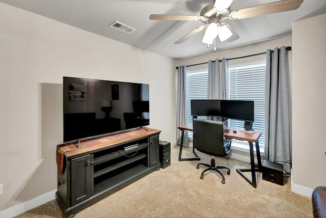 home office featuring ceiling fan, light colored carpet, and baseboards