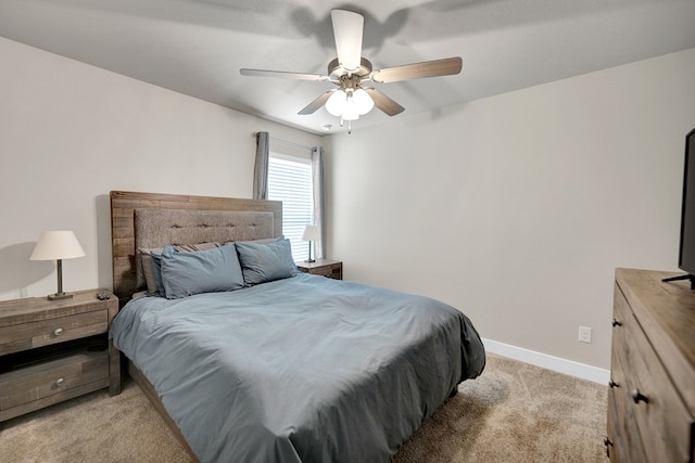 bedroom featuring light carpet, baseboards, and a ceiling fan