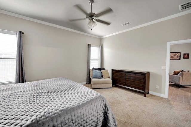 bedroom with light carpet, crown molding, baseboards, and ceiling fan