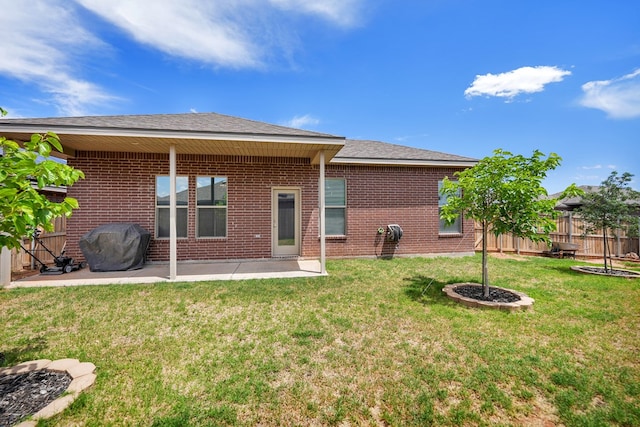 rear view of house featuring brick siding and a patio