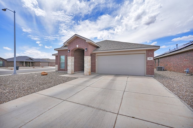 view of front of home featuring brick siding, concrete driveway, an attached garage, and a shingled roof