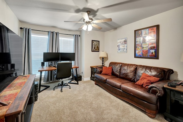 carpeted office with ceiling fan and baseboards