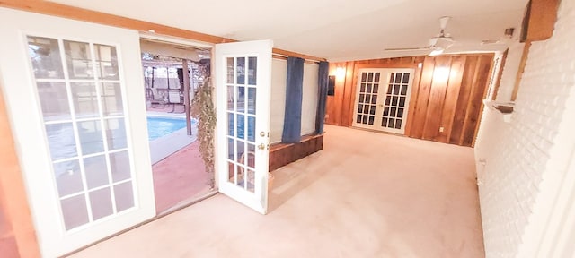 carpeted empty room with ceiling fan and french doors