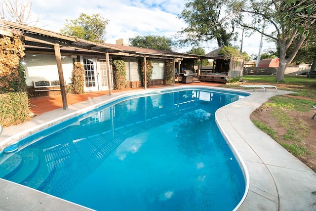 view of pool featuring a deck and a diving board