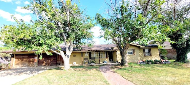 ranch-style home with a garage and a front lawn