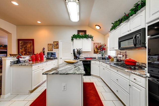 6920 Stonehenge Rd, Odessa, TX 79765 - kitchen with black appliances, a kitchen island, light tile patterned floors, light stone countertops, and white cabinetry