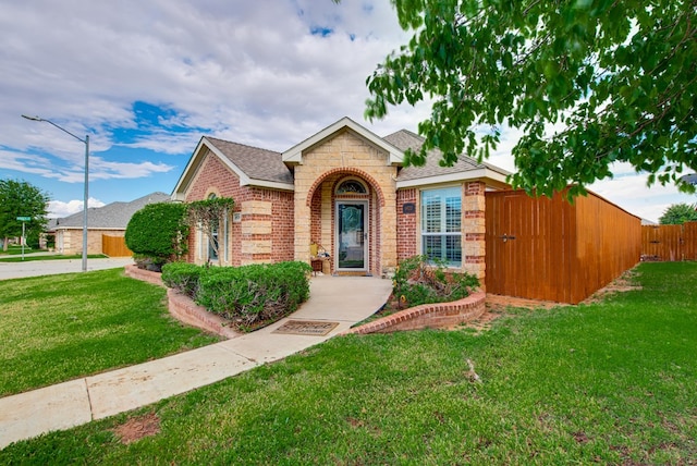 6920 Stonehenge Rd, Odessa, TX 79765 - view of front of house featuring brick siding and a shingled roof