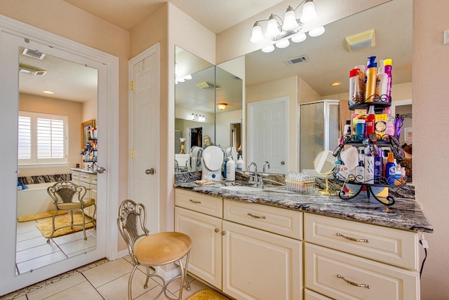 6920 Stonehenge Rd, Odessa, TX 79765 - full bath featuring a shower stall, tile patterned floors, vanity, and a tub