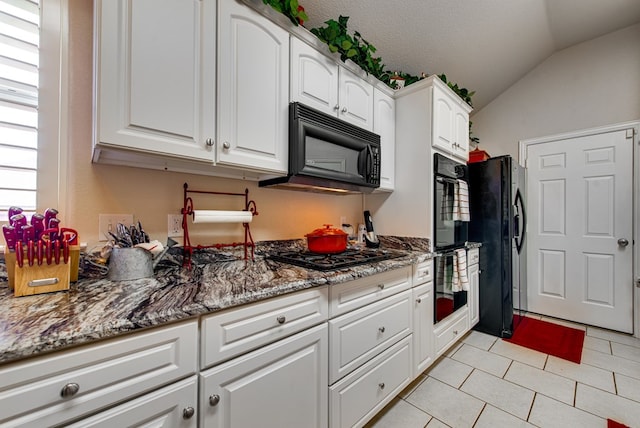6920 Stonehenge Rd, Odessa, TX 79765 - kitchen with black appliances, vaulted ceiling, white cabinets, light tile patterned floors, and stone countertops