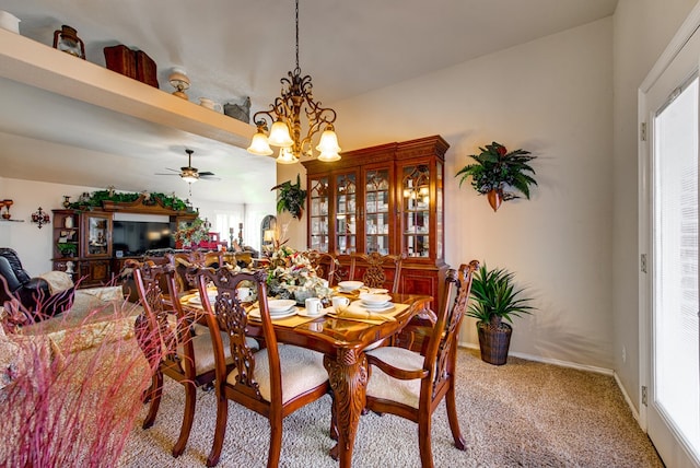 6920 Stonehenge Rd, Odessa, TX 79765 - dining area featuring light colored carpet, a chandelier, and a ceiling fan