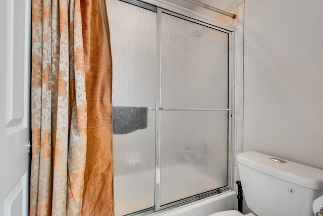 6920 Stonehenge Rd, Odessa, TX 79765 - bathroom with toilet and combined bath / shower with glass door