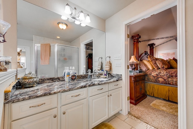 6920 Stonehenge Rd, Odessa, TX 79765 - full bathroom with ensuite bath, a stall shower, vanity, and tile patterned floors
