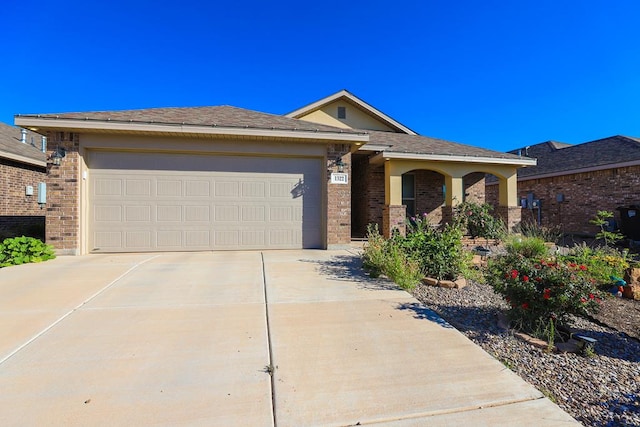 1322 E 89th St, Odessa, TX 79765 - single story home with concrete driveway, brick siding, and a garage
