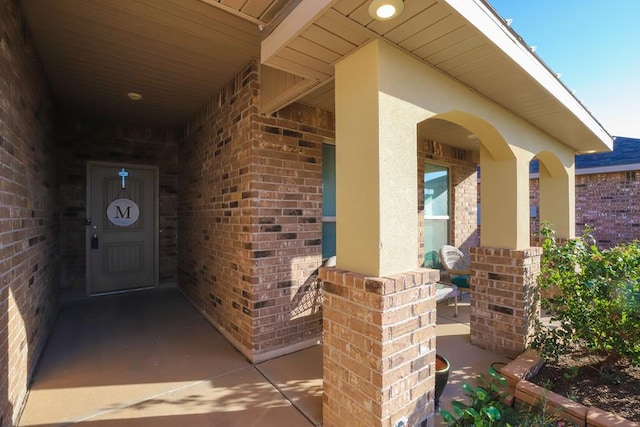 1322 E 89th St, Odessa, TX 79765 - view of exterior entry featuring brick siding and a porch