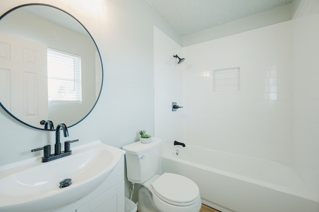 1613 E 52nd St, Odessa, TX 79762 - bathroom featuring toilet, vanity, washtub / shower combination, and a textured ceiling