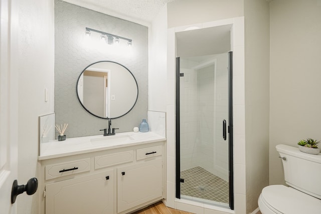 1613 E 52nd St, Odessa, TX 79762 - full bath with toilet, vanity, a shower stall, and a textured ceiling