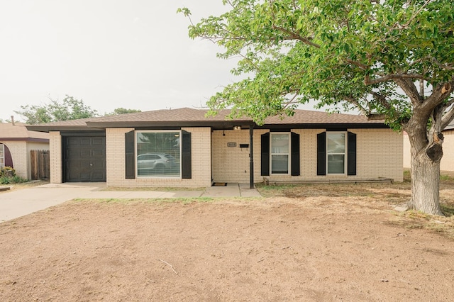 1613 E 52nd St, Odessa, TX 79762 - ranch-style house with driveway, a garage, and brick siding