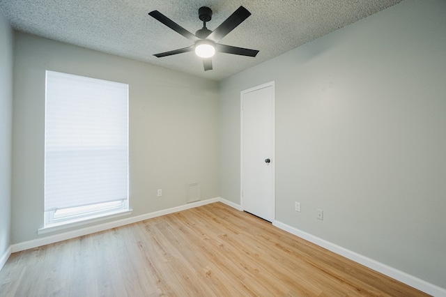 1613 E 52nd St, Odessa, TX 79762 - unfurnished room featuring wood finished floors, baseboards, ceiling fan, and a textured ceiling