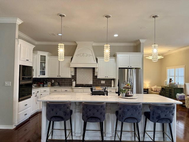 5 Muirfield Dr, Odessa, TX 79762 - kitchen with custom range hood, appliances with stainless steel finishes, dark wood-style floors, white cabinets, and backsplash