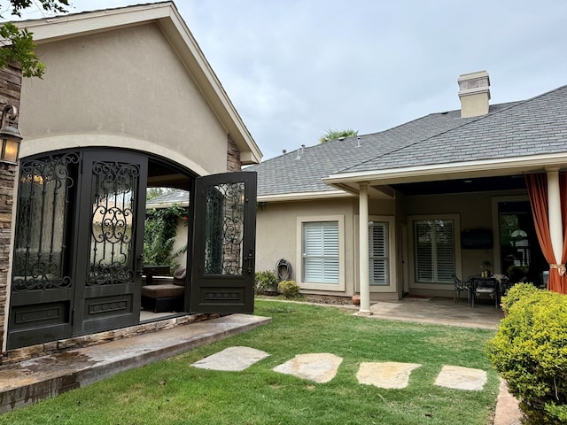 5 Muirfield Dr, Odessa, TX 79762 - view of exterior entry featuring stucco siding, a yard, and a patio
