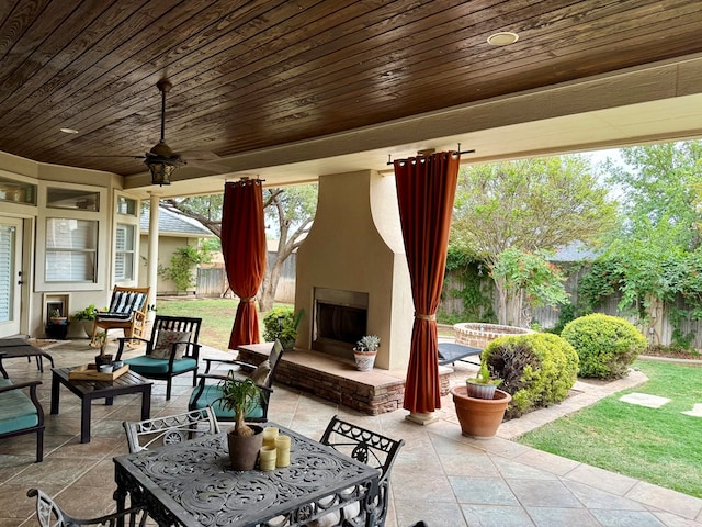 5 Muirfield Dr, Odessa, TX 79762 - fenced backyard with a patio, an outdoor living space with a fireplace, and outdoor dining space