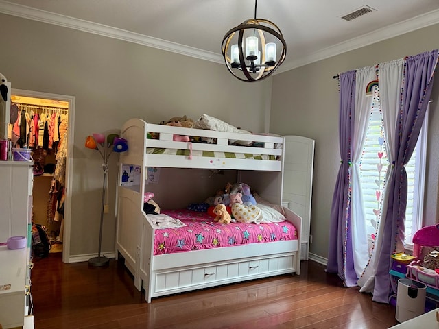 5 Muirfield Dr, Odessa, TX 79762 - bedroom featuring hardwood / wood-style flooring, ornamental molding, a chandelier, and a spacious closet
