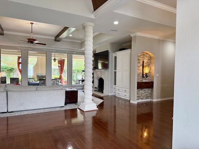 5 Muirfield Dr, Odessa, TX 79762 - living area featuring a fireplace with raised hearth, a ceiling fan, wood finished floors, crown molding, and arched walkways