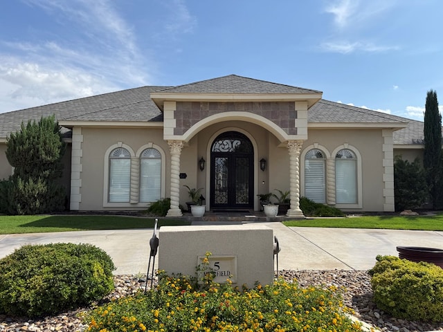 5 Muirfield Dr, Odessa, TX 79762 - view of front facade with french doors, roof with shingles, and stucco siding